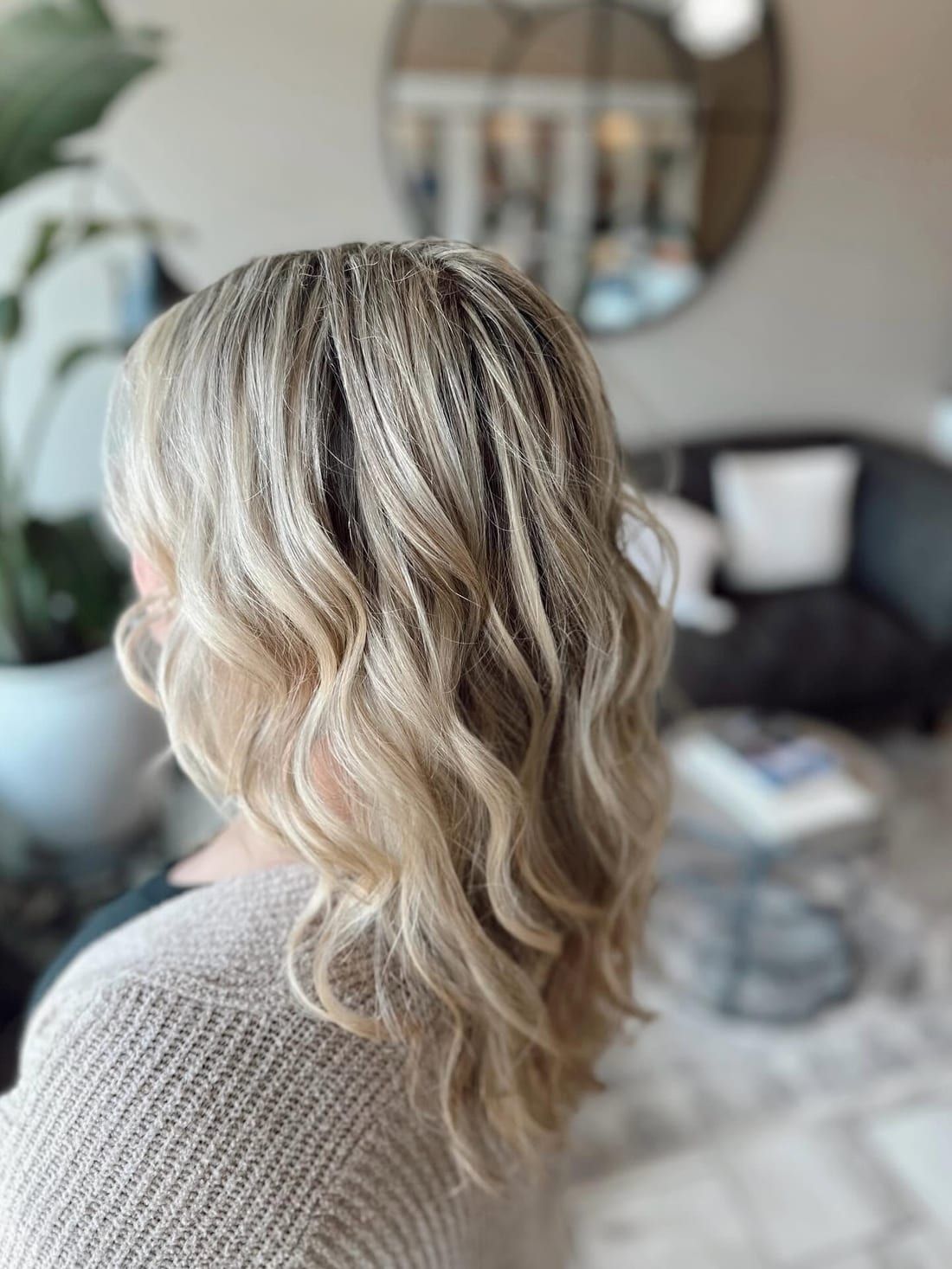 Soft beachy waves through dimensional blonde hair, styled in the lounge at Alora Salon in Pittsburgh