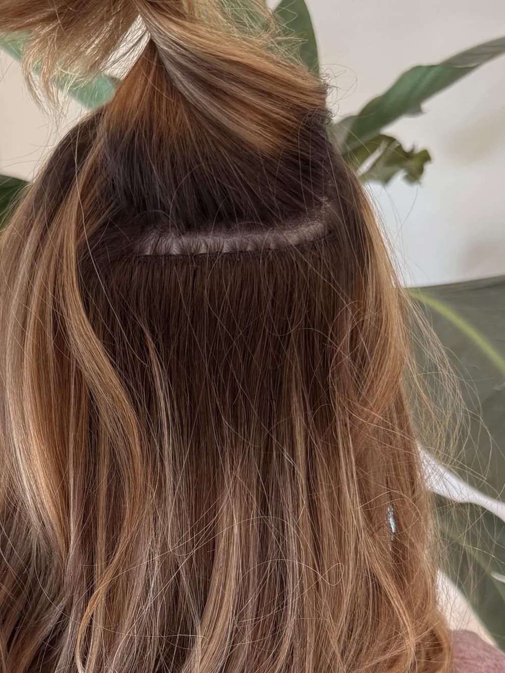 A hand-tied weft hair extension fitted close to the root at Alora Salon in Pittsburgh