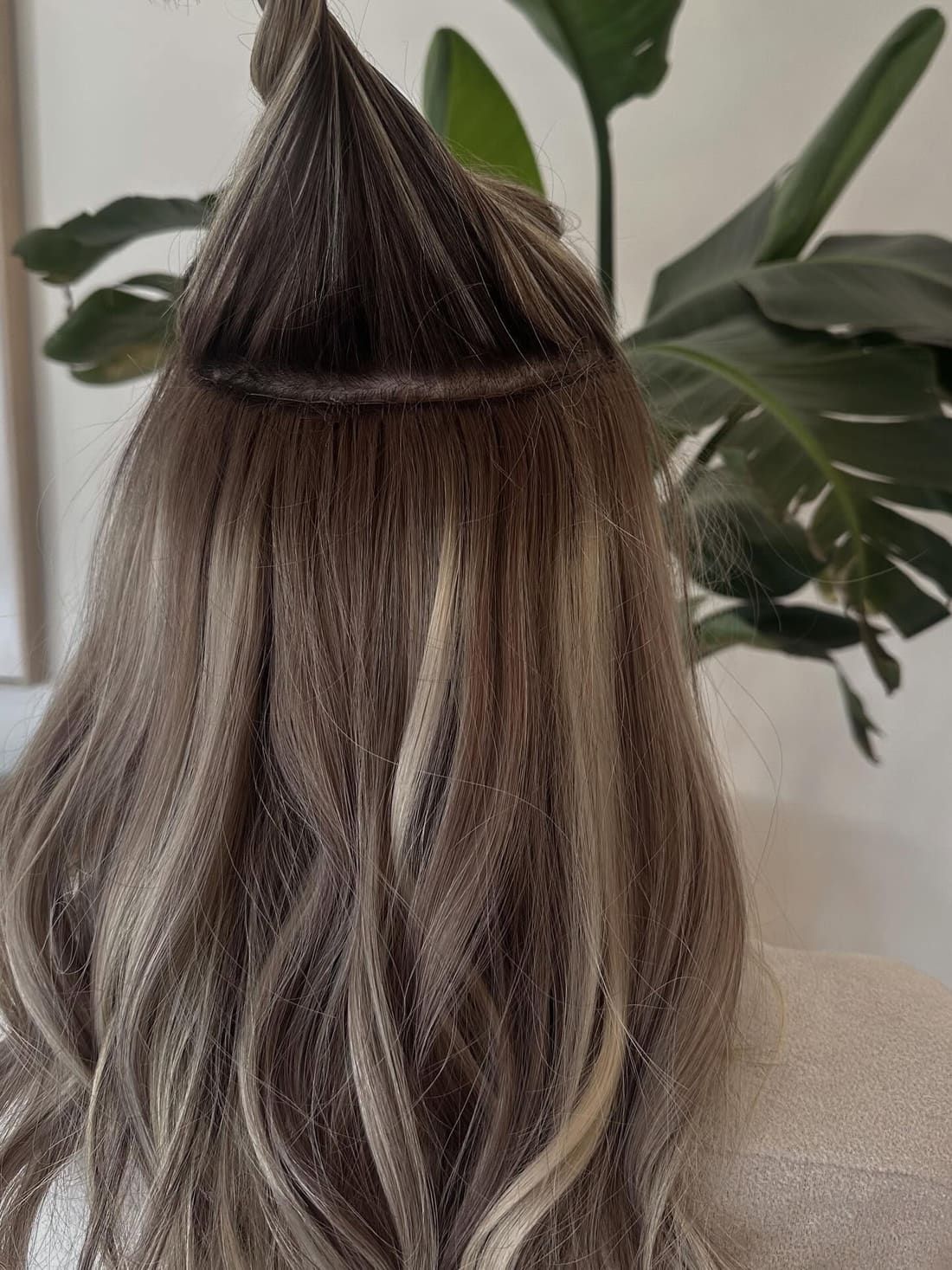 Long hand-tied weft extensions blended through dimensional blonde hair at Alora Salon in Pittsburgh